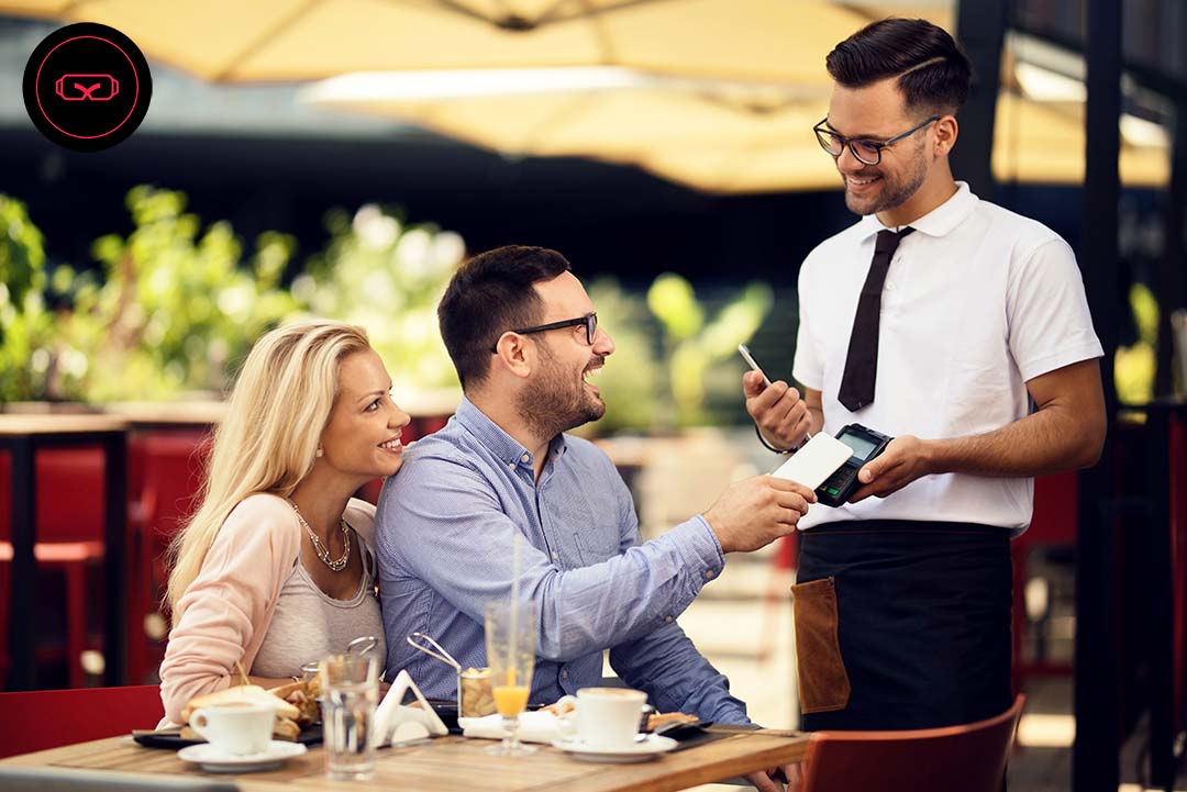 Image of happy couple chatting with a waiter